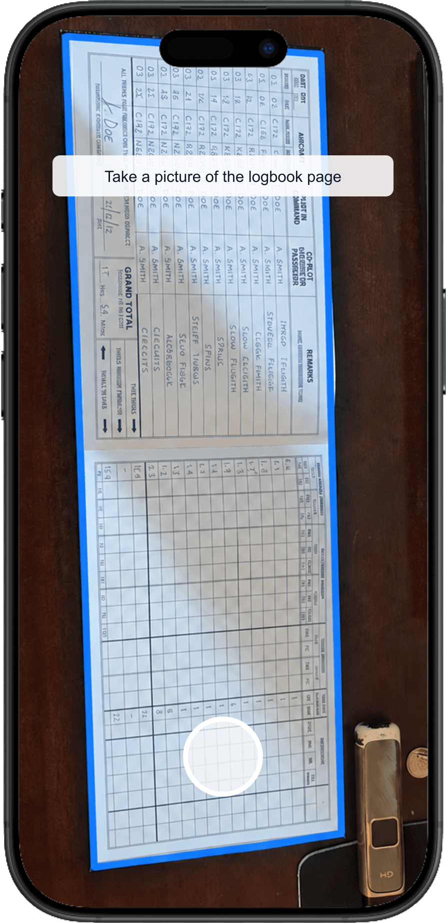 A paper pilot logbook page filling the TopLog camera screen